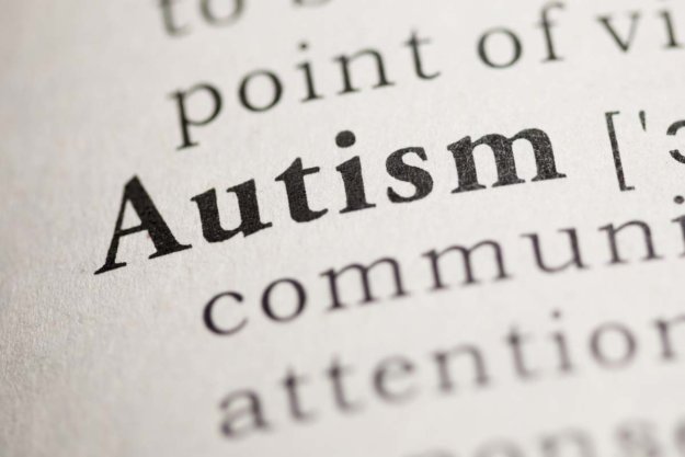 what-is-autism a person looks up the textbook definition of autism to learn what is autism