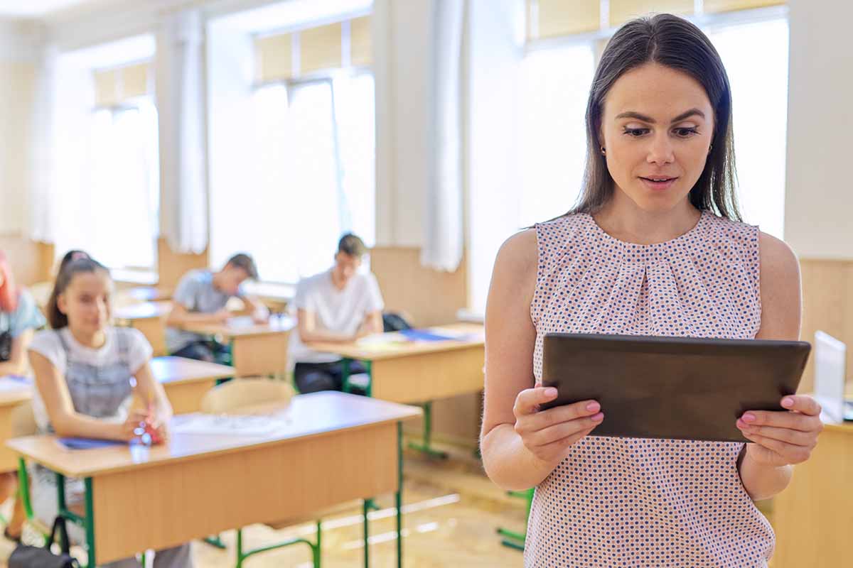 What to Expect in Applied Behavior Analysis teacher looking an ipad