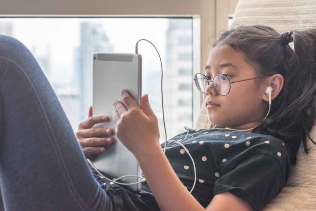 Managing Screen Time for Children With Autism child plays on tablet