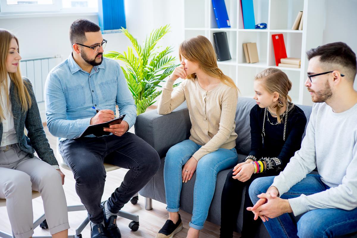 Family Therapist for Autism in Fort Worth, Texas a group of people talking to a family therapist for autism