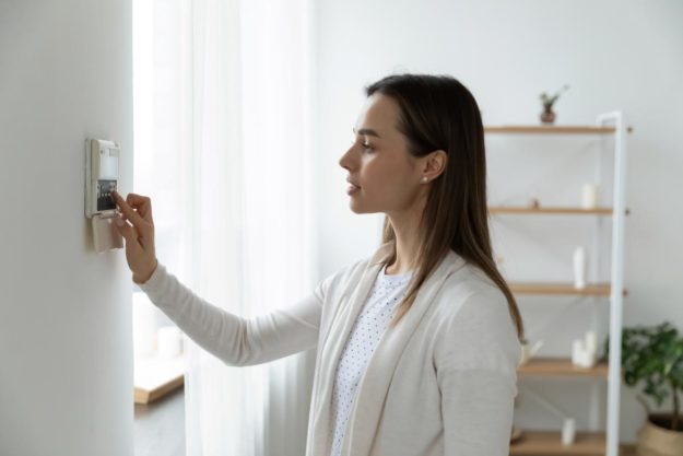 Home Safety Tips For Families With Autistic Children parent-checking-alarm-as-part-of-home-safety-tips